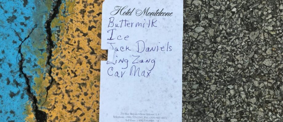 Shopping list on Hotel Monteleone stationery on pavement: buttermilk, ice, Jack Daniels, ling zang, Car Max.